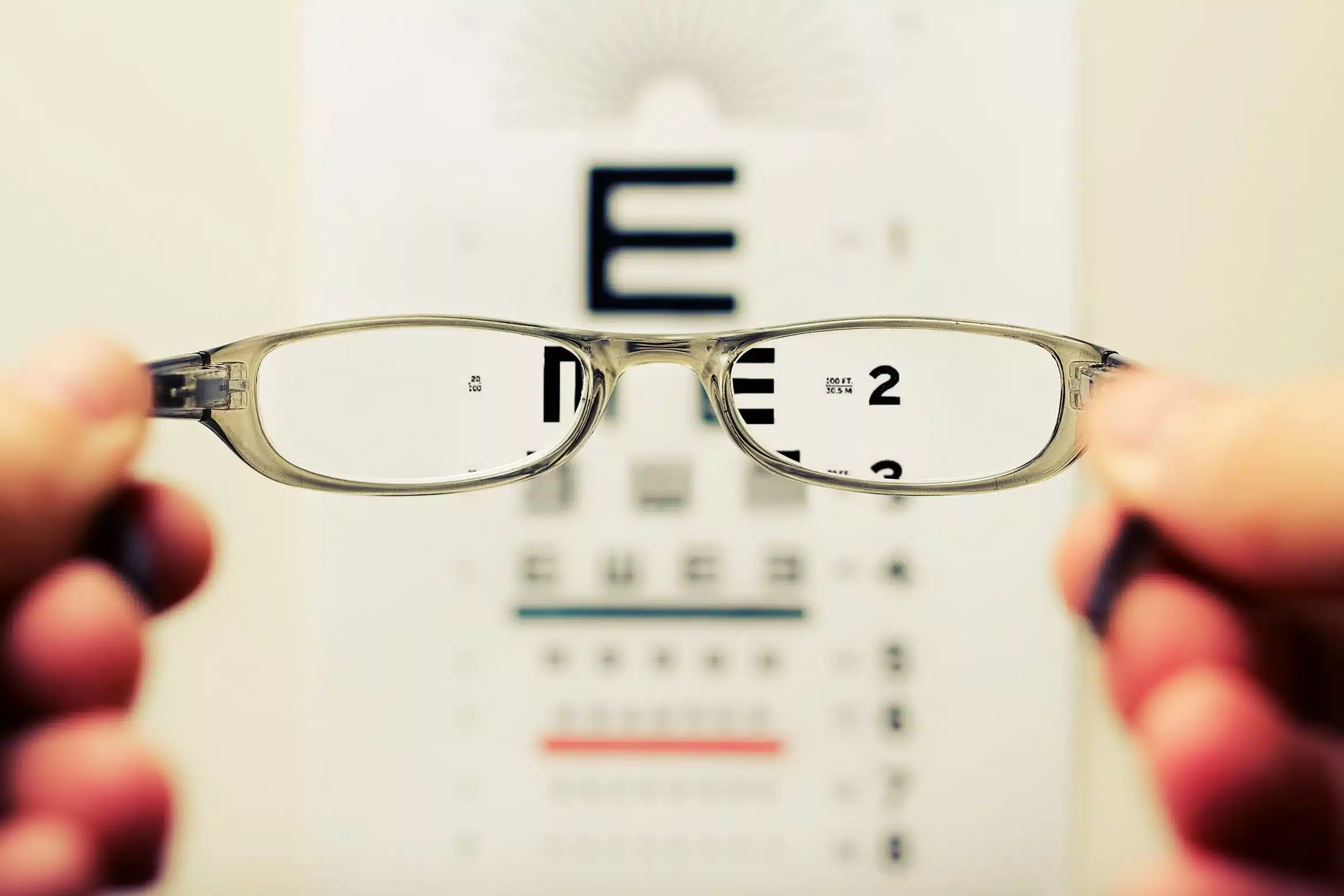 A pair of glasses being held up in an eye test